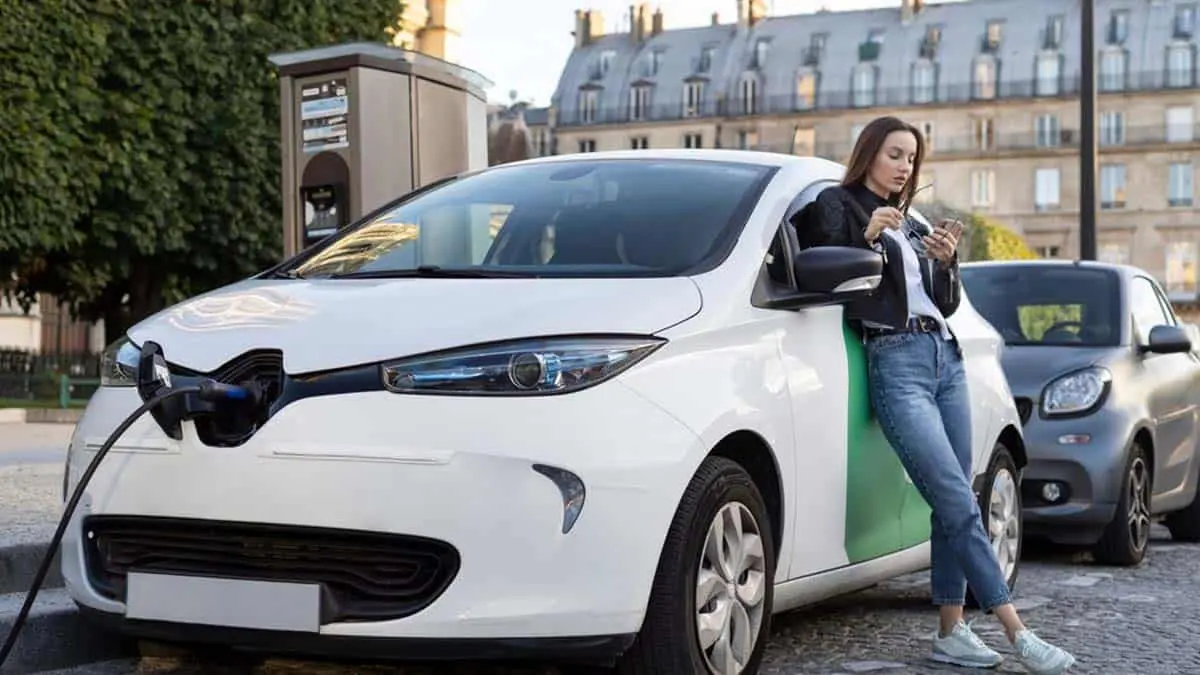 Coche el&eacute;ctrico cargando en la calle